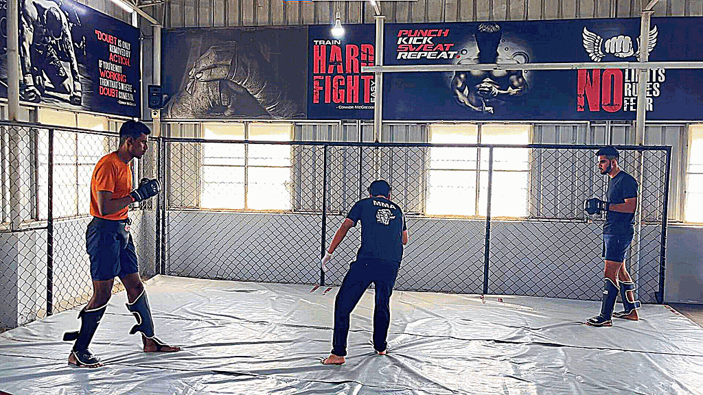 Author in black is ready to fight the opponent in orange in an MMA duel